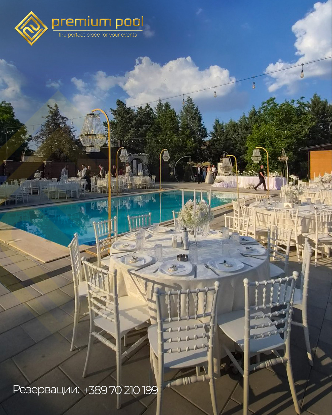 Sunlit wedding table setting beside a turquoise pool with gold Premium Pool branding.