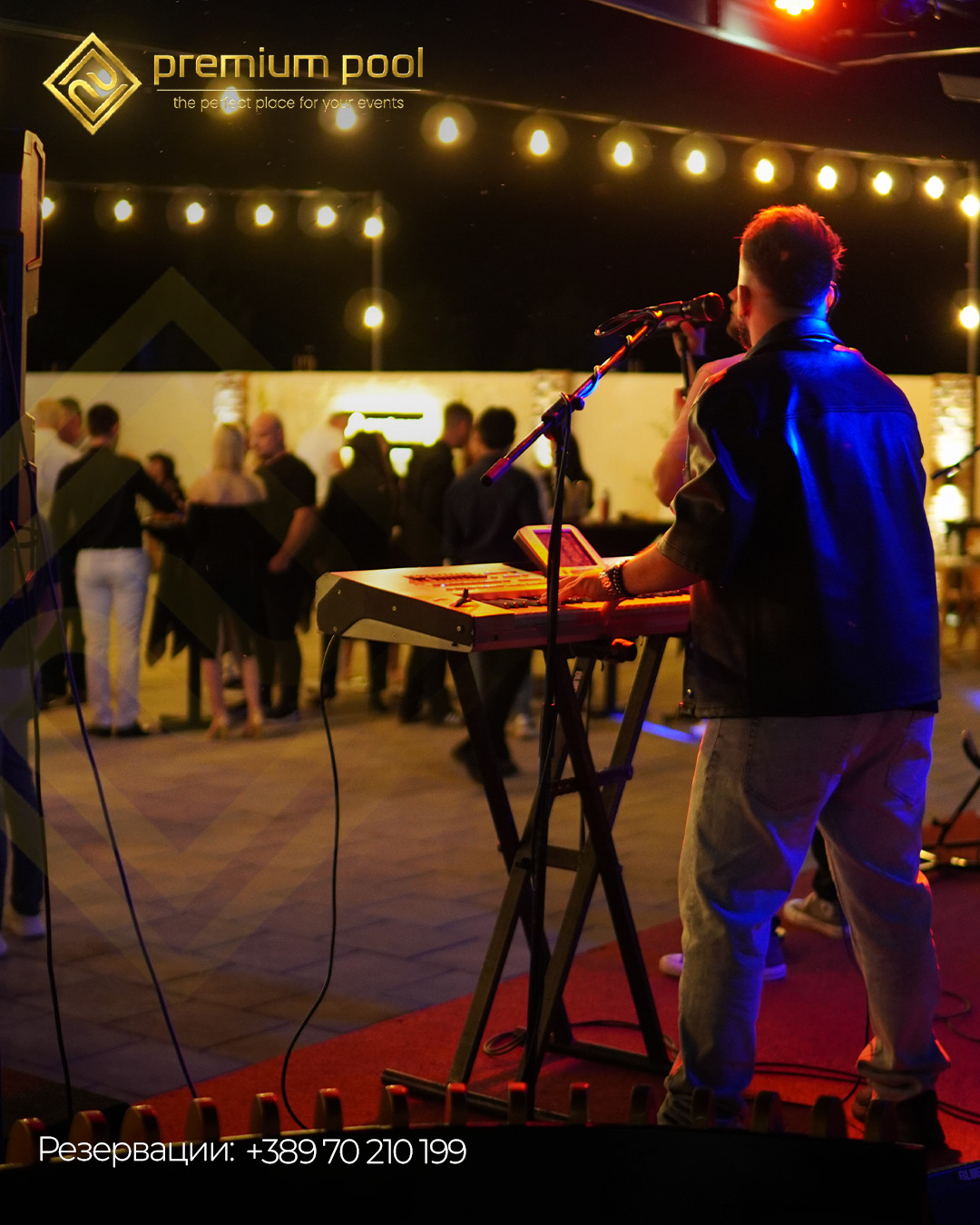 Singer at a keyboard under warm outdoor string lights at Premium Pool.